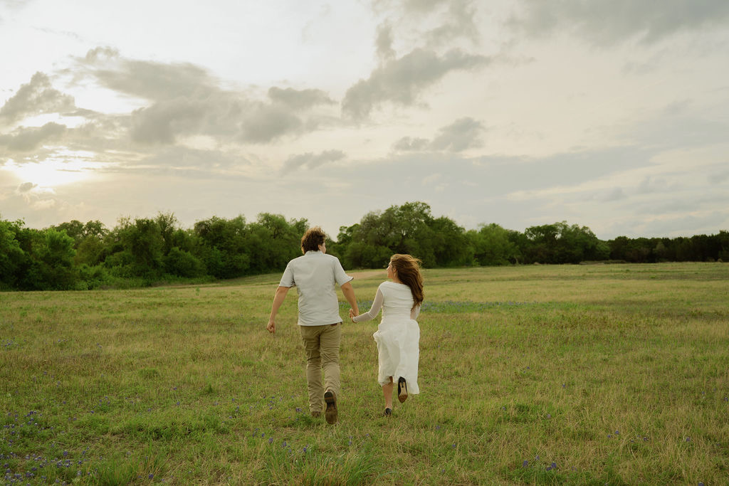 Sam and Rachel walking through a Texas hill country field